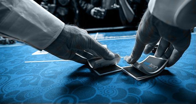 dealer shuffling Betiton branded cards on a blackjack online real money table