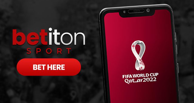 a smartphone with the fifa world cup qatar 2022 logo on its screen and the betiton sport logo with a button saying bet here
