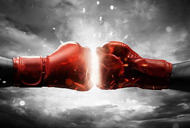 two red boxing gloves fist bumping