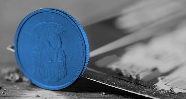 a blue coin standing upside down next to a finished scratchcard