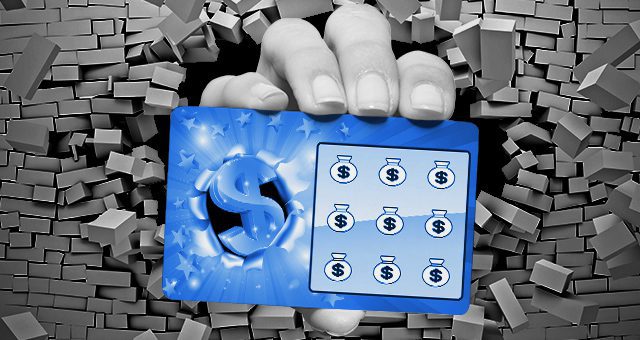 a hand breaks through a wall and holds a scratch card