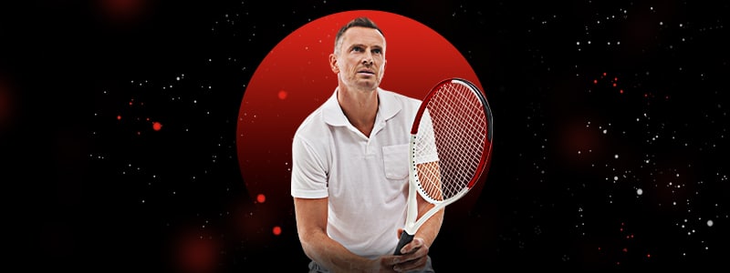 male tennis player holding a racket and waiting for the ball
